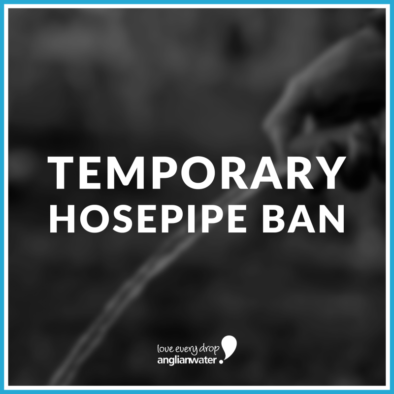 Notice on dark background with blue and white border that reads 'Temporary Hosepipe Ban'.